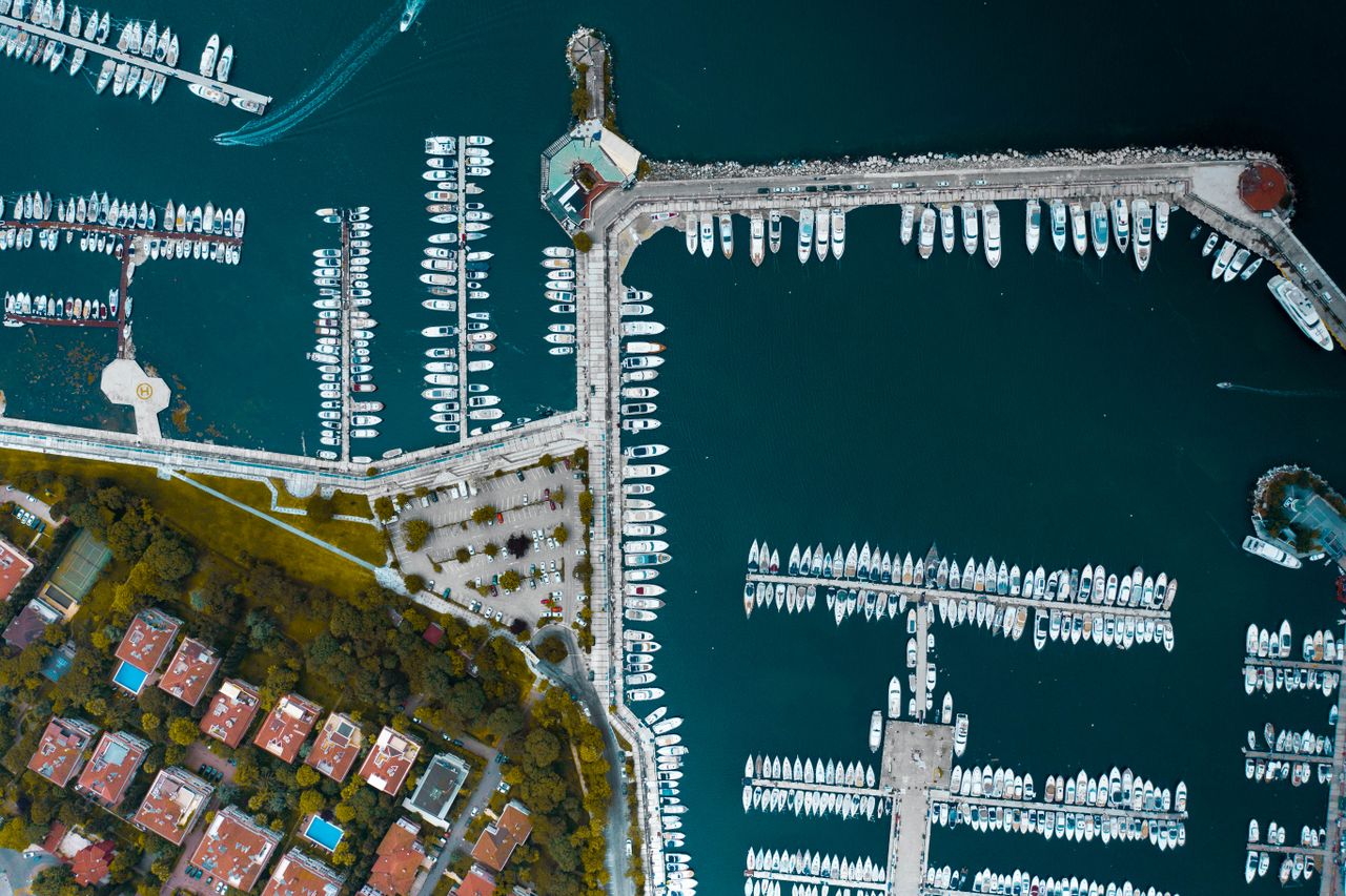 Aerial view of boats docked across a marina harbor